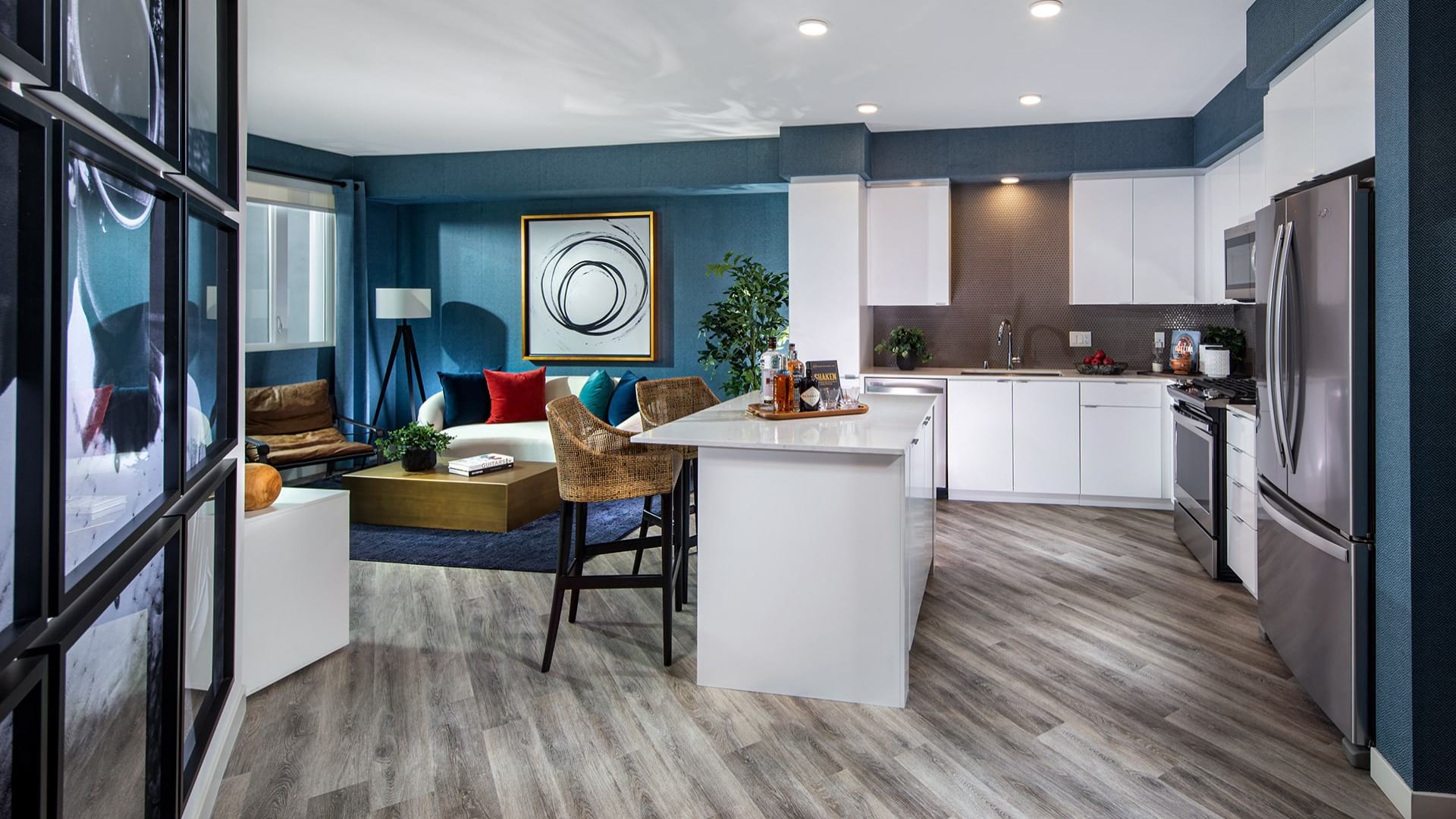 Modern floor plan at Neptune Marina with a kitchen, kitchen island, barstools and adjacent living room