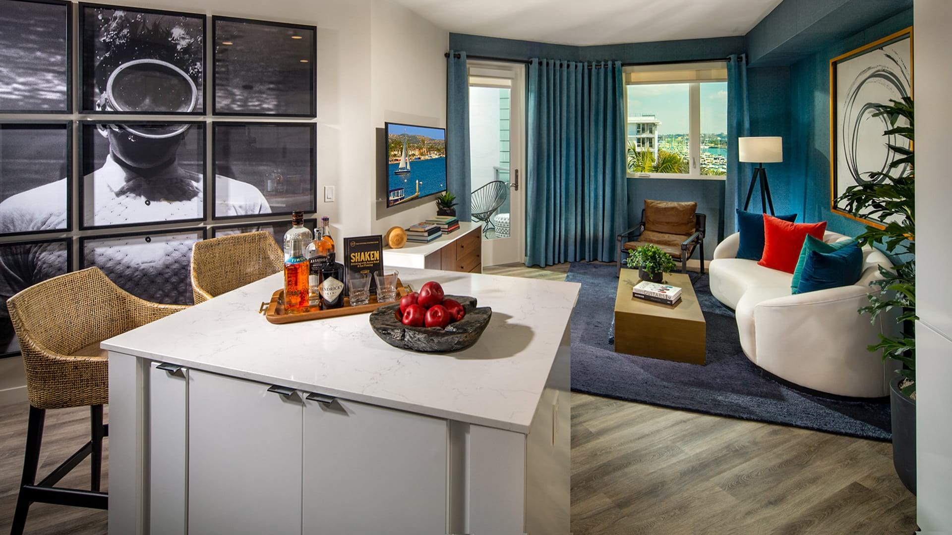 Colorful floor plan at Neptune Marina with a kitchen island, barstools, living room, and door leading to a balcony